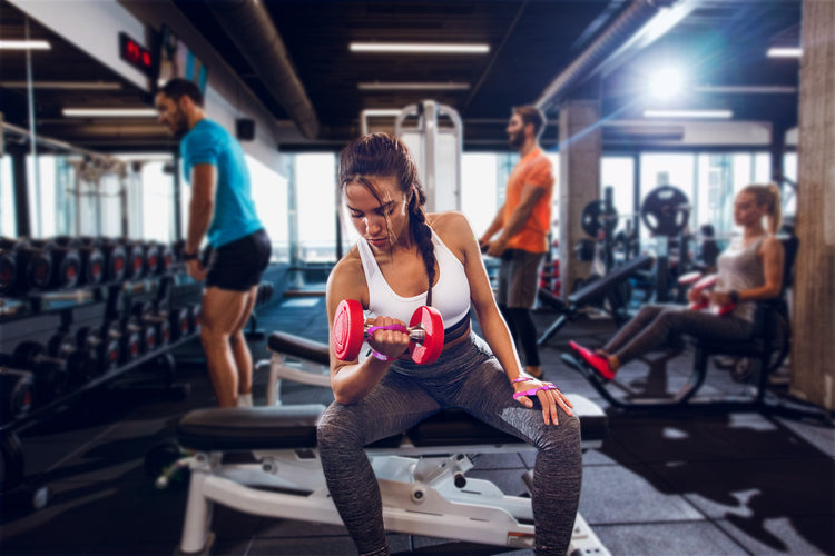 female lifting weights wearing Gym Skins by STKR