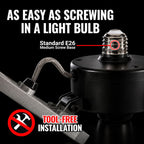 A black socket adapter with a braided metal wire lead and a threaded screw base, shown on a white background with marketing text reading 'AS EASY AS SCREWING IN A LIGHT BULB,' 'Standard E26 Medium Screw Base,' and 'TOOL-FREE INSTALLATION.'.