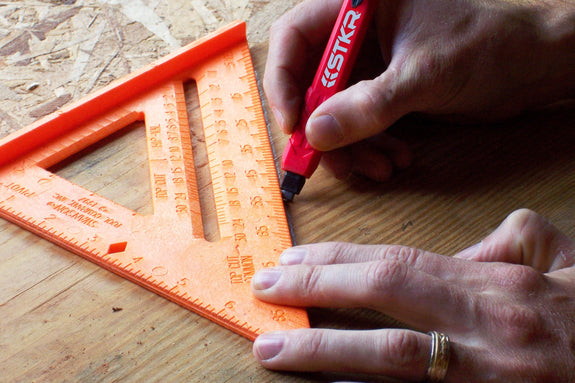 Marking along a speed square with the STKR Mechanical Carpenter Pencil
